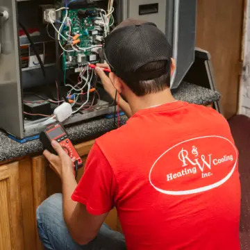 worker performing furnace maintenance